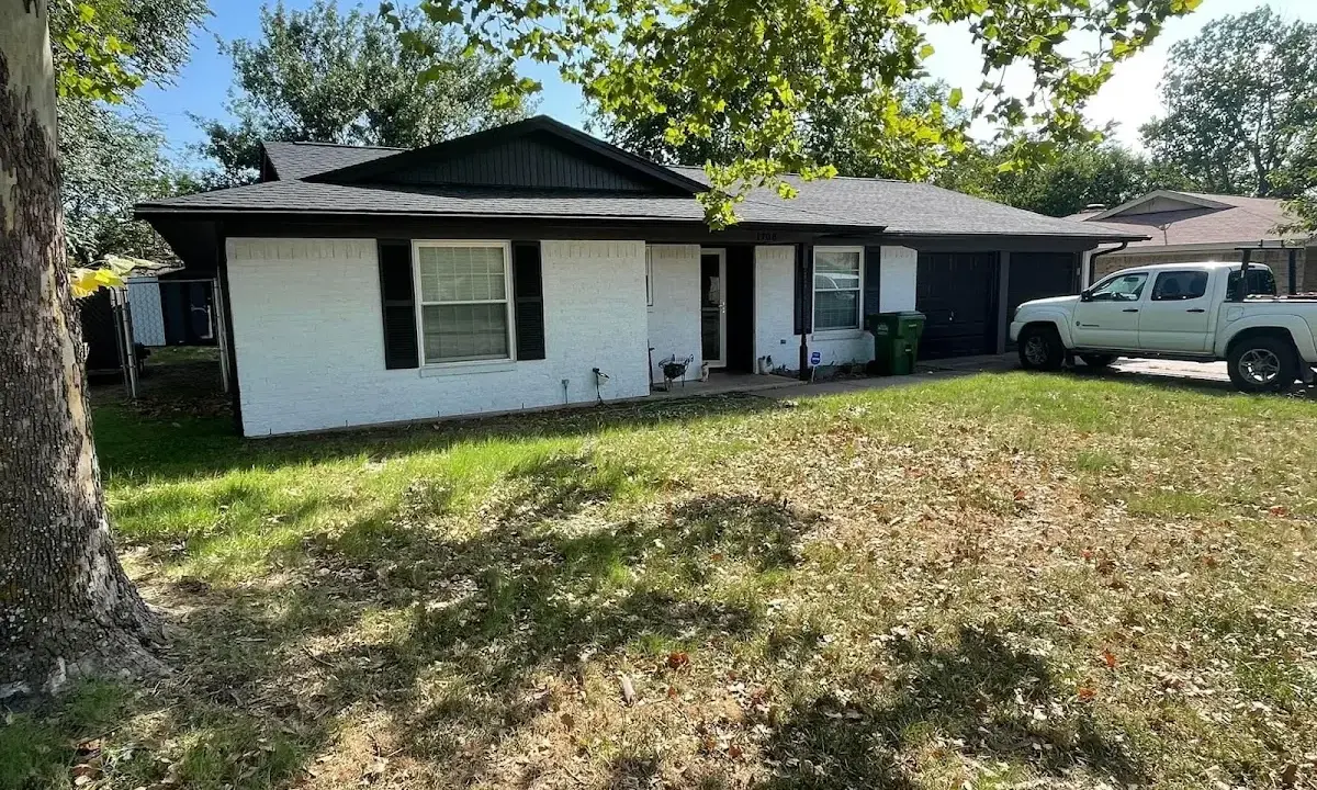 Professional roofing crew working on a residential roof in Lynbrook